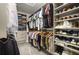Organized walk-in closet with ample hanging space and shelving for shoes and clothing at 12180 Sonnet Ave, Orlando, FL 32832