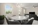 Dining area with marble-top table, six chairs, and connecting living room at 12180 Sonnet Ave, Orlando, FL 32832