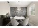 Elegant dining area featuring a modern chandelier and stylish accent wall at 12180 Sonnet Ave, Orlando, FL 32832