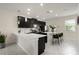 Bright kitchen boasting a large island, sleek black cabinets, and modern pendant lighting at 12180 Sonnet Ave, Orlando, FL 32832