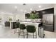 Modern kitchen featuring dark cabinets, stainless steel appliances, and a stylish island with seating at 12180 Sonnet Ave, Orlando, FL 32832