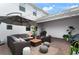 Patio showcases outdoor seating, shade umbrella, string lights, and well-maintained landscaping at 12180 Sonnet Ave, Orlando, FL 32832