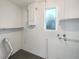 The clean basement features painted white block walls and utility hookups at 1311 Bryn Mawr Ave, Lake Wales, FL 33853