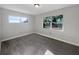 Clean and bright bedroom featuring a new carpet, two windows, and fresh paint at 1311 Bryn Mawr Ave, Lake Wales, FL 33853