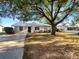 Charming single-story home with a well-maintained front yard, mature shade tree, and a new metal roof at 1311 Bryn Mawr Ave, Lake Wales, FL 33853