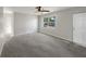Spacious, freshly painted living room with new carpet and lots of natural light from the large window at 1311 Bryn Mawr Ave, Lake Wales, FL 33853