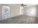The bright living room features neutral paint and updated ceiling fan at 1311 Bryn Mawr Ave, Lake Wales, FL 33853