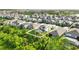 An aerial view of a home with a screened pool, solar panels, and green surroundings at 13202 Spring Grove Way, Winter Garden, FL 34787