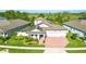Aerial shot of a home with solar panels, pristine landscaping, and a brick driveway at 13202 Spring Grove Way, Winter Garden, FL 34787