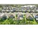 Overhead view of a home with a screened pool, patio, and solar panels in a suburban neighborhood at 13202 Spring Grove Way, Winter Garden, FL 34787