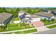 Aerial view of a home with a well-kept lawn, solar panels, and beautiful landscaping at 13202 Spring Grove Way, Winter Garden, FL 34787