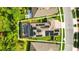 Aerial view of a home with solar panels, screened-in pool, patio and lush landscaping at 13202 Spring Grove Way, Winter Garden, FL 34787