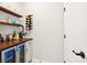 A stylish bar area with wood countertop, wine rack, mini fridge, and floating shelves provides a great space for drinks at 13202 Spring Grove Way, Winter Garden, FL 34787