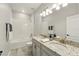 Bathroom featuring granite sink, tile floors, white tiling, and mirror at 13202 Spring Grove Way, Winter Garden, FL 34787