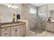 Modern bathroom with large shower featuring gray tile, dual vanities and gray stone countertops at 13202 Spring Grove Way, Winter Garden, FL 34787