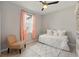 Cozy bedroom with hardwood floors, chair, and large window that provides plenty of natural light at 13202 Spring Grove Way, Winter Garden, FL 34787