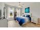 Bright bedroom with tile floors, white trim, ceiling fan, and plenty of natural light at 13202 Spring Grove Way, Winter Garden, FL 34787
