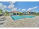 Community pool with a covered lounge area and various seating options at 13202 Spring Grove Way, Winter Garden, FL 34787