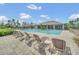 Inviting community pool area with plenty of lounge chairs for relaxation at 13202 Spring Grove Way, Winter Garden, FL 34787