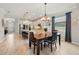 An open concept dining room is located near the kitchen with bar seating and large windows that bring in natural light at 13202 Spring Grove Way, Winter Garden, FL 34787