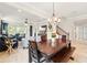 A dining room with an open floor plan to the kitchen and living room offers a comfortable layout for relaxing and entertaining at 13202 Spring Grove Way, Winter Garden, FL 34787
