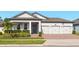Well-maintained single-Gathering home with a three-car garage and manicured lawn at 13202 Spring Grove Way, Winter Garden, FL 34787
