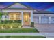 Home exterior at twilight with decorative lighting highlighting the front entrance at 13202 Spring Grove Way, Winter Garden, FL 34787