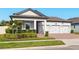 Charming single-story home showcasing a brick driveway, three-car garage, and lush landscaping at 13202 Spring Grove Way, Winter Garden, FL 34787