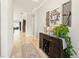 Light and airy hallway featuring wood floors, a console table, and decorative wall art at 13202 Spring Grove Way, Winter Garden, FL 34787