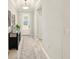 Welcoming hallway with wood floors, a decorative rug, and a view of the front door at 13202 Spring Grove Way, Winter Garden, FL 34787