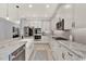 Modern kitchen with stone countertops, white cabinets, stainless steel appliances, and ample storage at 13202 Spring Grove Way, Winter Garden, FL 34787