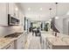 Stylish kitchen with a gas cooktop, center island, and a view of the dining area at 13202 Spring Grove Way, Winter Garden, FL 34787