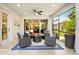 Covered lanai with plush seating, outdoor access, and partial view of living area at 13202 Spring Grove Way, Winter Garden, FL 34787