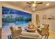 Enclosed lanai with a cozy fire pit, lounge seating, and a sparkling pool view at 13202 Spring Grove Way, Winter Garden, FL 34787