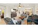 A spacious living room features plenty of seating and an open floor plan that connects the kitchen and dining area at 13202 Spring Grove Way, Winter Garden, FL 34787