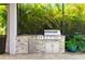 Outdoor kitchen with stainless steel grill and stone accents, surrounded by lush landscaping at 13202 Spring Grove Way, Winter Garden, FL 34787
