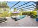 A luxurious screened-in pool area features chaise lounges and umbrella for enjoying sunny days in style at 13202 Spring Grove Way, Winter Garden, FL 34787