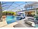 Inviting screened-in pool area with spa, chaise lounges and an outdoor seating area for relaxation and entertainment at 13202 Spring Grove Way, Winter Garden, FL 34787