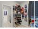 Walk-in closet with custom storage solutions, including shelving for shoes and handbags at 13202 Spring Grove Way, Winter Garden, FL 34787