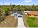 Aerial view of a modern single-Gathering home with a driveway and manicured lawn at 13673 Sw 43 Cir, Ocala, FL 34473