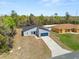 Aerial view of a modern single-Gathering home with a driveway and manicured lawn at 13673 Sw 43 Cir, Ocala, FL 34473