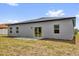 The back exterior of the home features a patio and sliding glass doors at 13673 Sw 43 Cir, Ocala, FL 34473