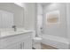 The bathroom features a tub and shower combination, a vanity with a countertop and tiled walls at 13673 Sw 43 Cir, Ocala, FL 34473
