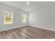 This bedroom has wood-look flooring and two windows that provide natural light to the room at 13673 Sw 43 Cir, Ocala, FL 34473