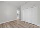 An empty bedroom with wood-look floors and a large closet, ready for your personal touch at 13673 Sw 43 Cir, Ocala, FL 34473