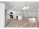 Modern kitchen with white cabinets, stainless steel appliances, and wood-look floors at 13673 Sw 43 Cir, Ocala, FL 34473