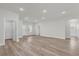 Spacious living room with wood-look floors, neutral walls, and abundant natural light at 13673 Sw 43 Cir, Ocala, FL 34473