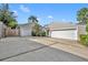 Exterior shot of the property showcasing a large concrete driveway and dual garages at 1370 Alberta Dr, Winter Park, FL 32789