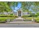 Inviting home featuring manicured landscaping, a brick walkway and a grand arched front door at 1370 Alberta Dr, Winter Park, FL 32789