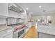 Gourmet kitchen boasts granite counters, stainless steel appliances, and white cabinetry at 1370 Alberta Dr, Winter Park, FL 32789
